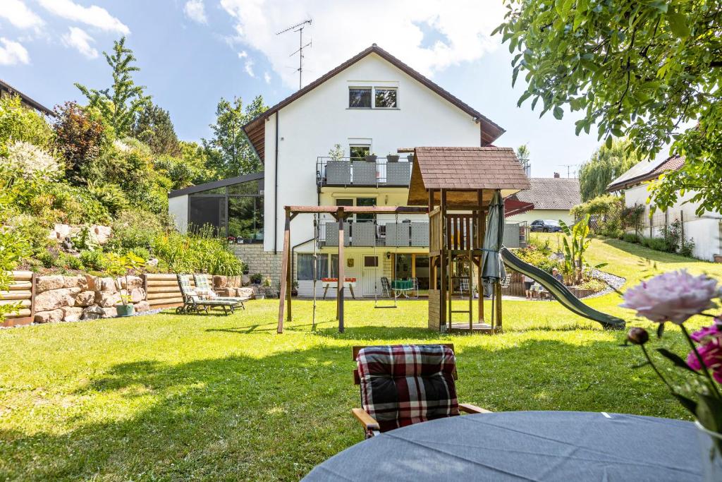 a house with a playground in the yard at Haus am Mühlenbach in Hilzingen