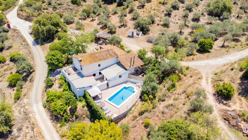 an aerial view of a house with a swimming pool at Cubo's Cortijo La Palmera in Cártama