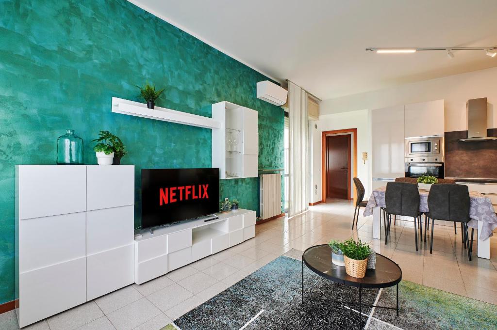 a living room with a tv and a kitchen at Casa Terrazzo - Centro Città e UniBG in Bergamo