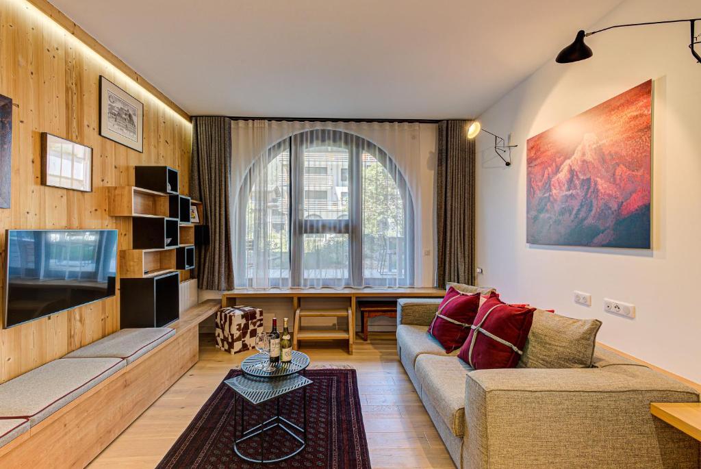 a living room with a couch and a tv at Apartment Chéserys, Alpes Travel, Les Praz Sleeps 2-4 in Chamonix-Mont-Blanc