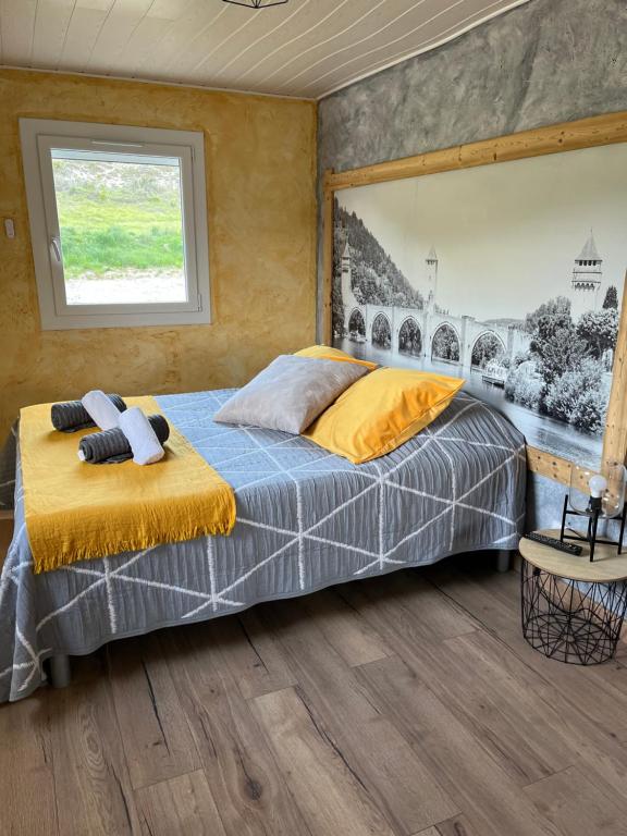a bedroom with a bed and a window at Chambres d'hôtes Le Malbouyssou in Lascabanes