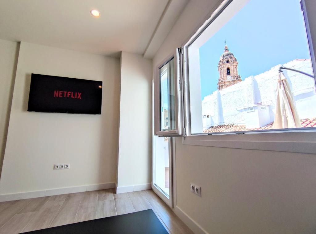 Televízia a/alebo spoločenská miestnosť v ubytovaní EDIFICIO DUQUE