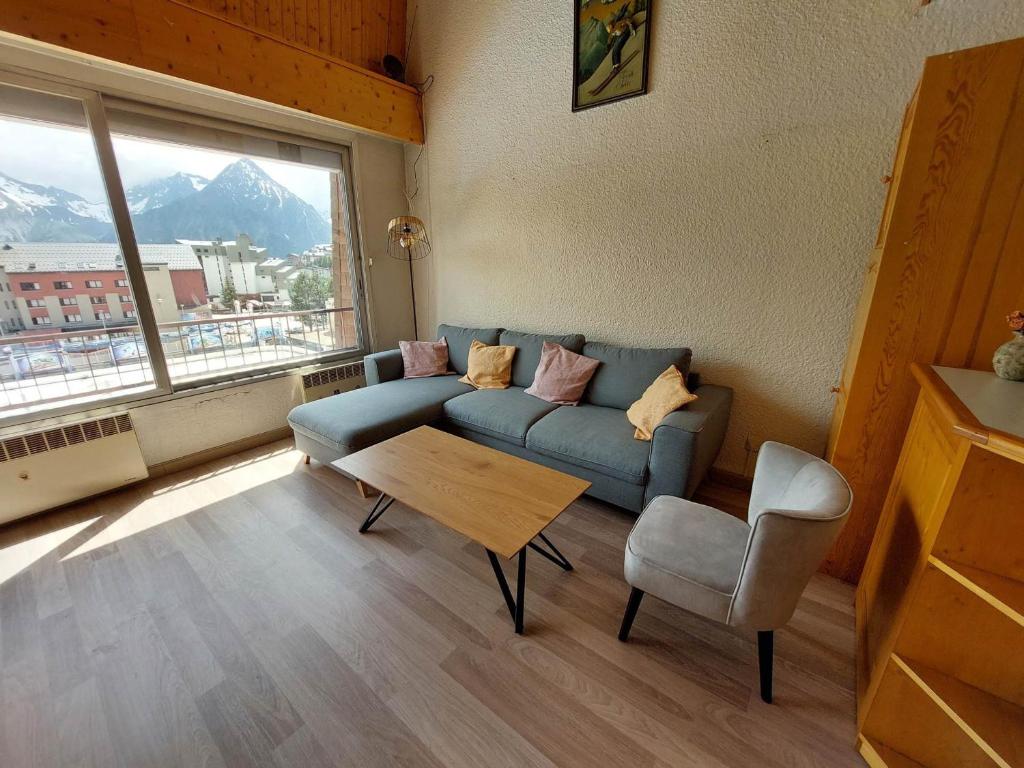 un salon avec un canapé, une table et une fenêtre dans l'établissement Appartement duplex spacieux 8 pers. au pied des pistes, centre station - FR-1-516-195, à Les Deux Alpes