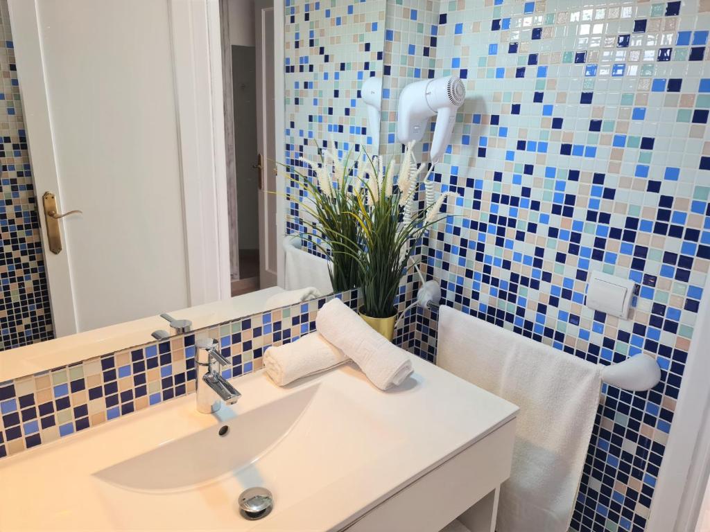 a bathroom with a sink and a mirror at Tabbu ibiza apartments in Playa d'en Bossa