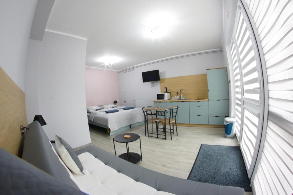 a living room with a couch and a bedroom at Dla Dwojga in Solina