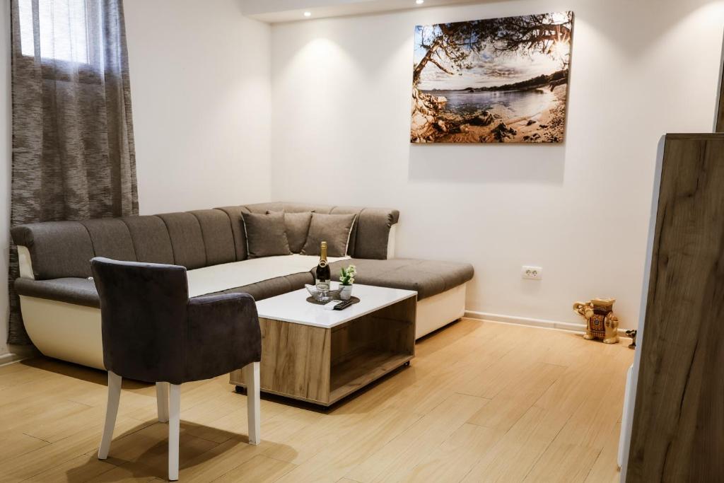 a living room with a couch and a table at Apartment Neiv in Tivat