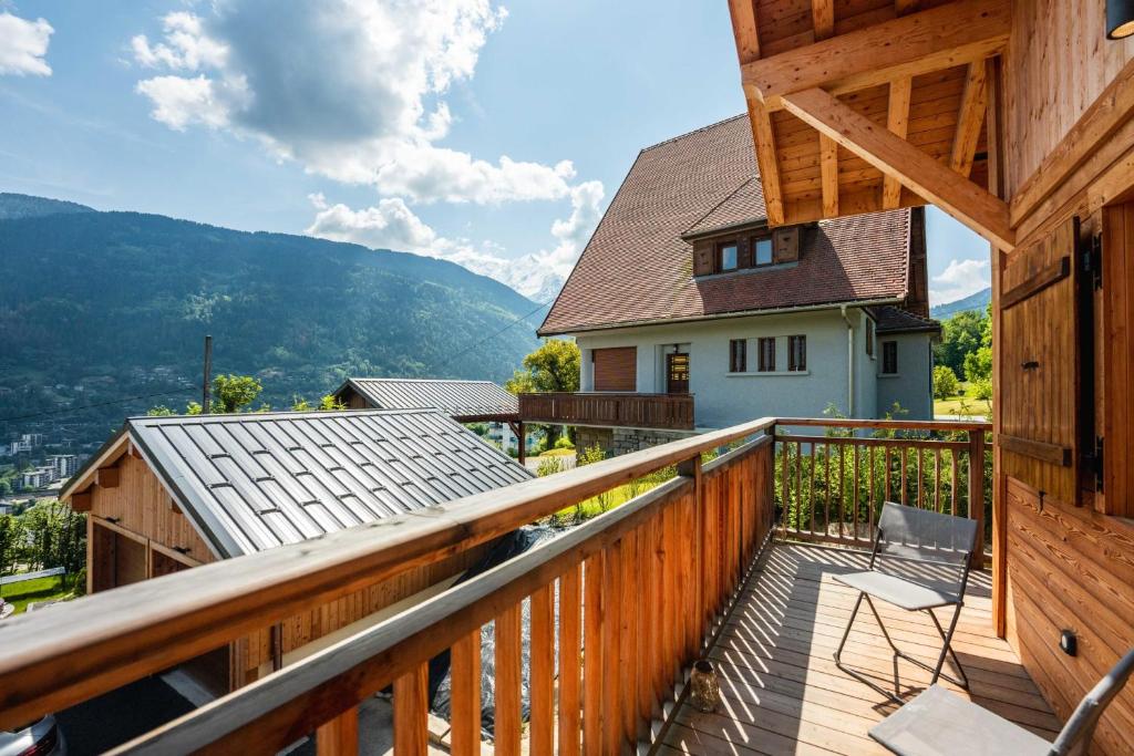 - un balcon en bois avec vue sur une maison dans l'établissement Sumptuous 4-star chalet for unforgettable stays, à Saint-Gervais-les-Bains