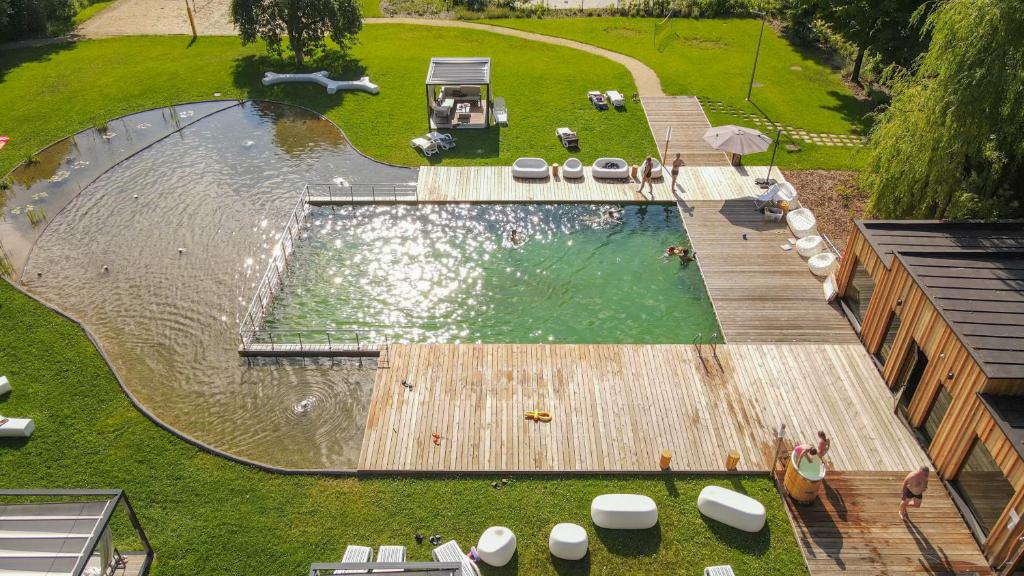 an overhead view of a swimming pool with a wooden deck at Enklawa Białowieska Forest & Spa in Hajnówka