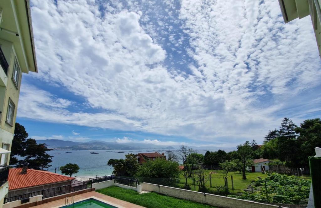 a view of the ocean from a house at Precioso apartamento con piscina in Pontevedra