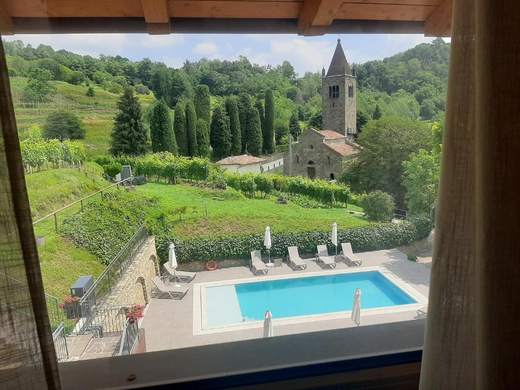 a view of a swimming pool from a window at Al-Colle in Sotto il Monte
