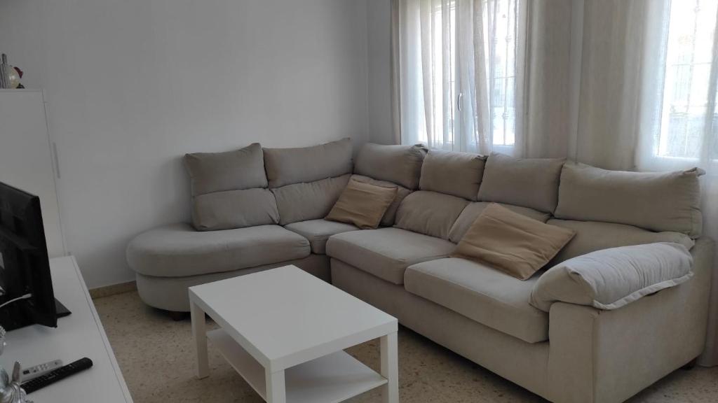 a living room with a couch and a table at Casa Rubio in Chiclana de la Frontera