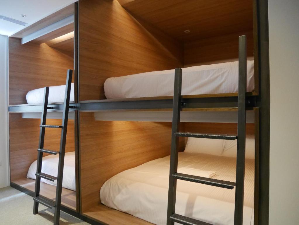Postel nebo postele na pokoji v ubytování Bouti City Capsule Inn