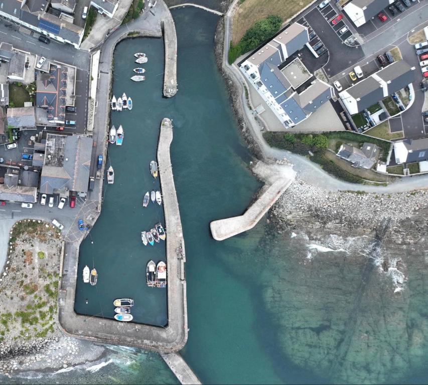 an aerial view of a harbor with boats in the water at Harbour view apartment in Annalong