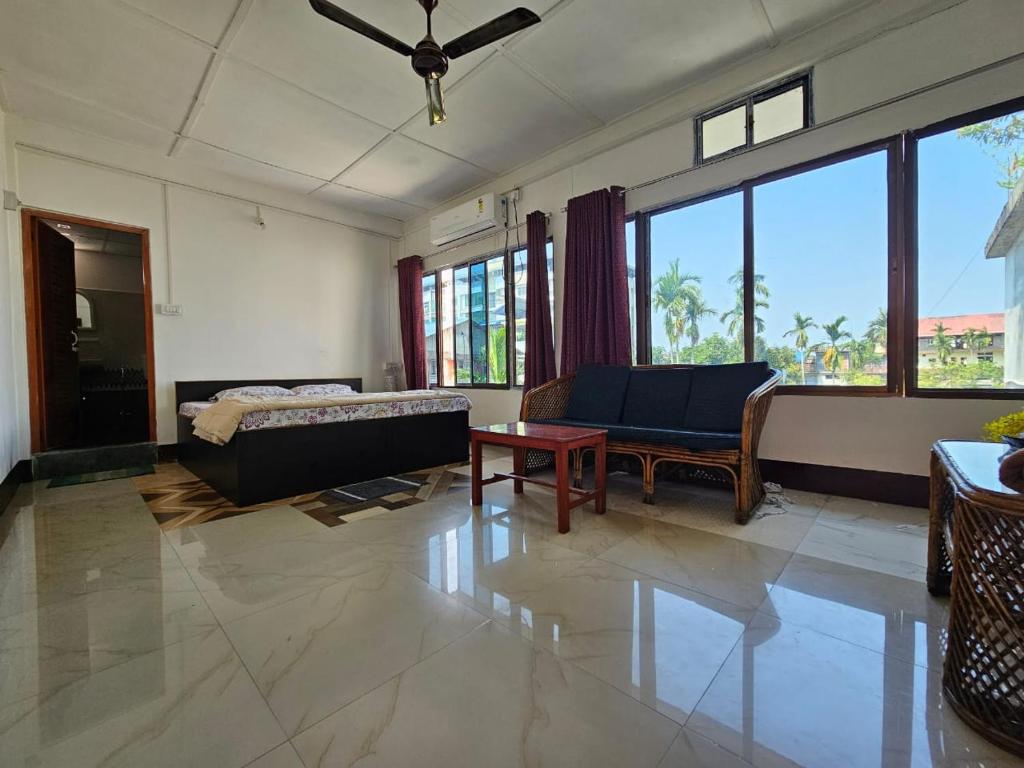 a living room with a couch and a table at Bhaskar Homestay in Dibrugarh