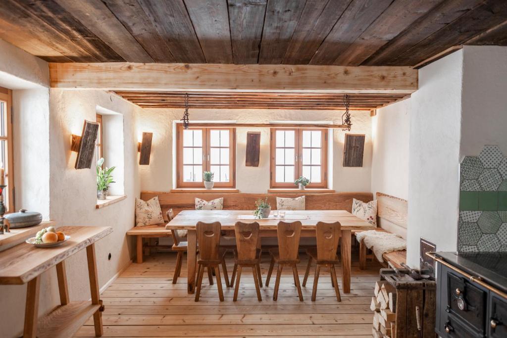 a large dining room with a table and chairs at Hasenalm in Schliersee