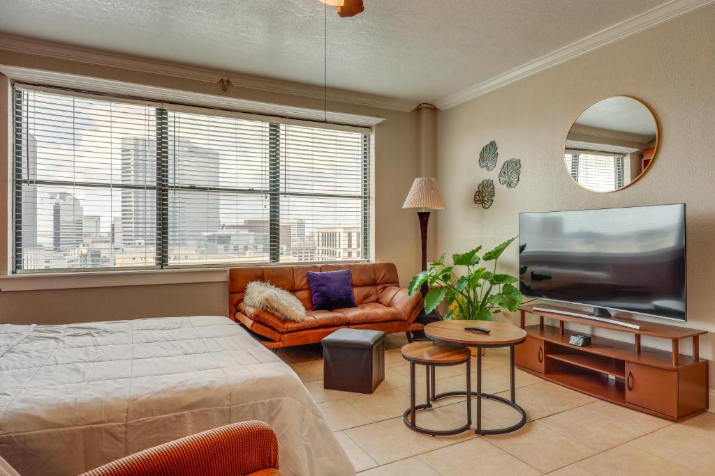 a bedroom with a bed and a flat screen tv at Downtown Jacksonville Studio with City Views! in Jacksonville