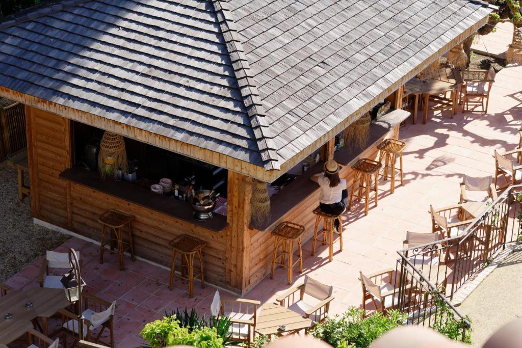 an overhead view of a bar with chairs and tables at La Ferme D'Augustin in Saint-Tropez