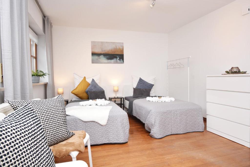 a bedroom with two beds and a dresser at NUE11-RI Apartment in Zirndorf in Zirndorf