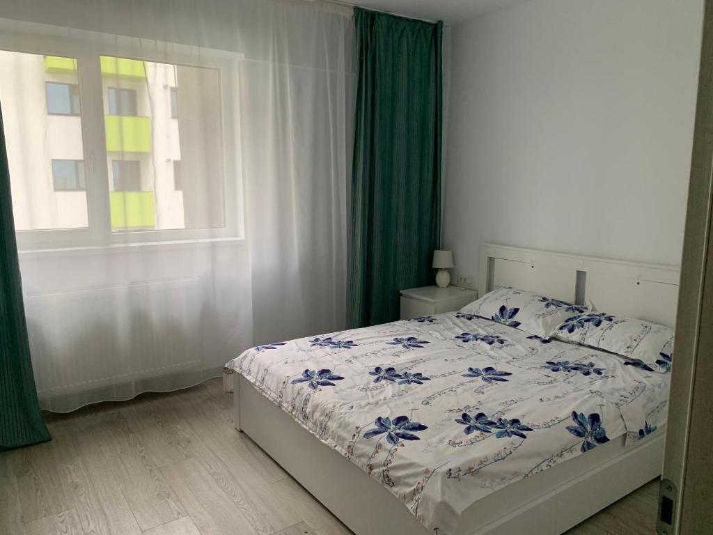 a bedroom with a bed and a window at Black&White Suites in Craiova