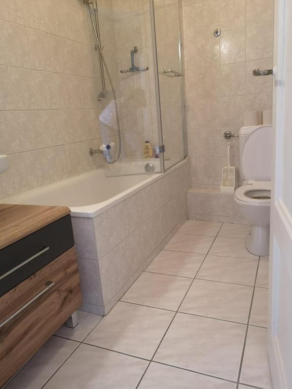 a bathroom with a tub and a toilet at hyper centre in Montreux