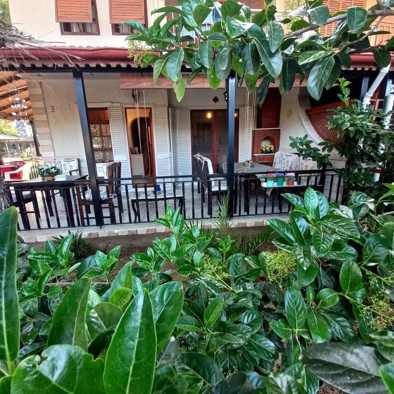 a house with a porch with chairs and plants at Family Holiday House in Aydın