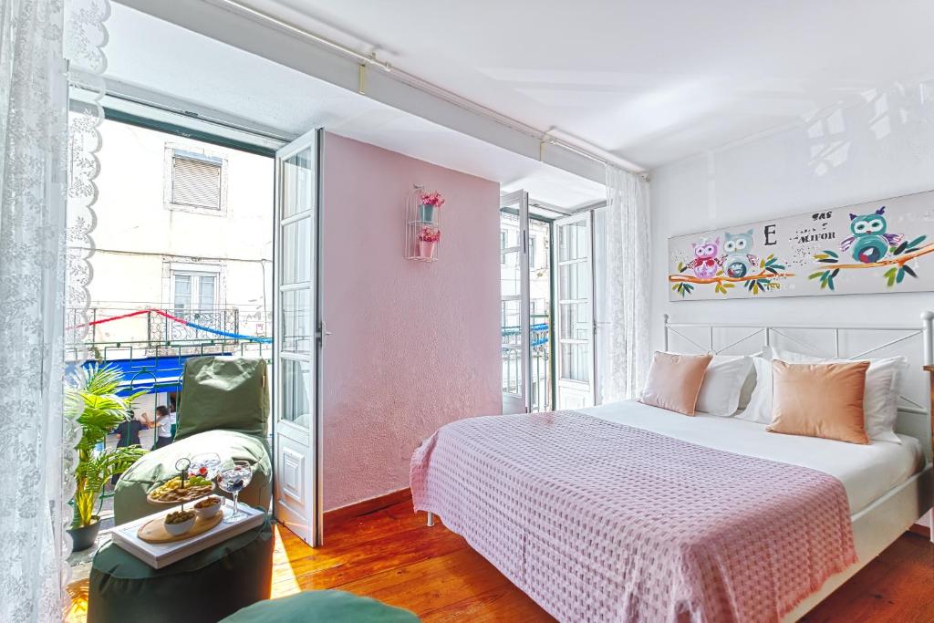 a bedroom with a bed and a large window at InLoveApartments - Alfama Balcony in Lisbon