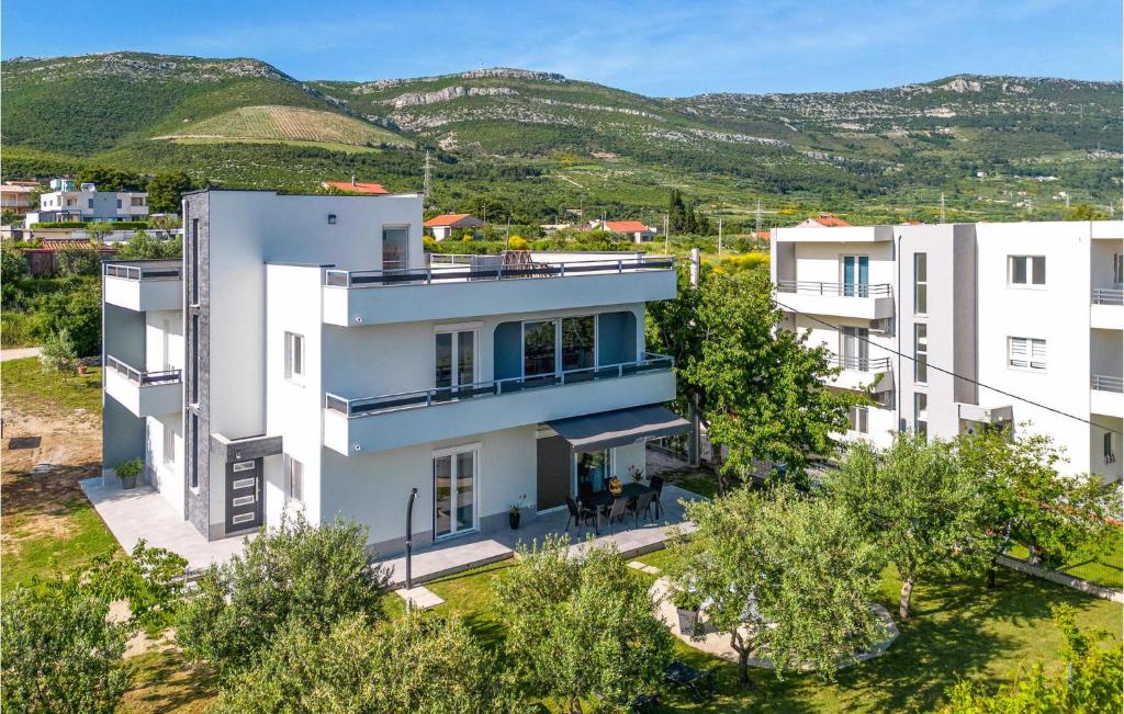 an aerial view of a house with mountains in the background at Nice Home In Kastel Novi With Jacuzzi in Kastel Novi