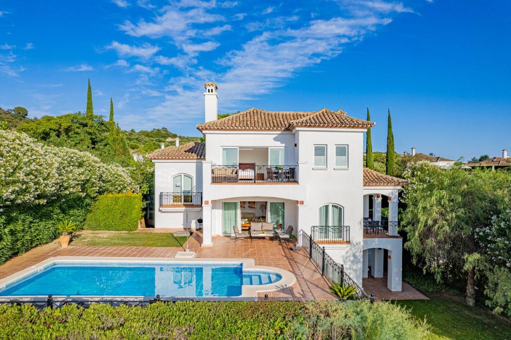 a villa with a swimming pool and a house at Arcos Gardens Sol Rent Golf in Arcos de la Frontera