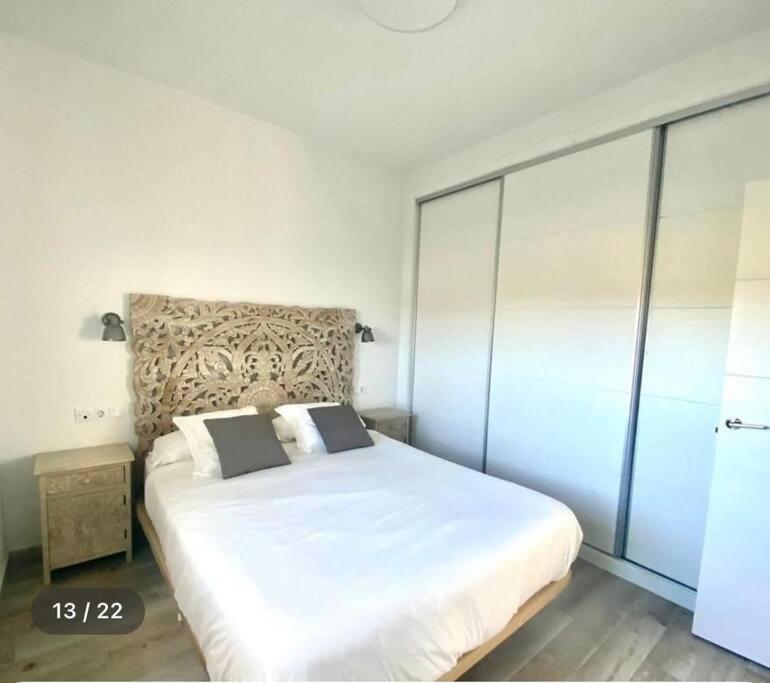 a bedroom with a large white bed in a room at Sunset view * Swimming pool* A/C in Tarifa