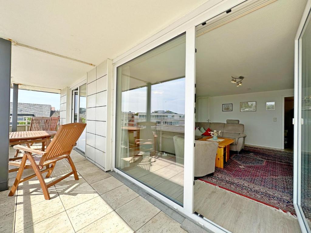 a sliding glass door on a patio with a living room at Dreizimmerwhg im Zentrum Westerland, Hanseatenhaus App 34 Balkon und Garage in Westerland (Sylt)