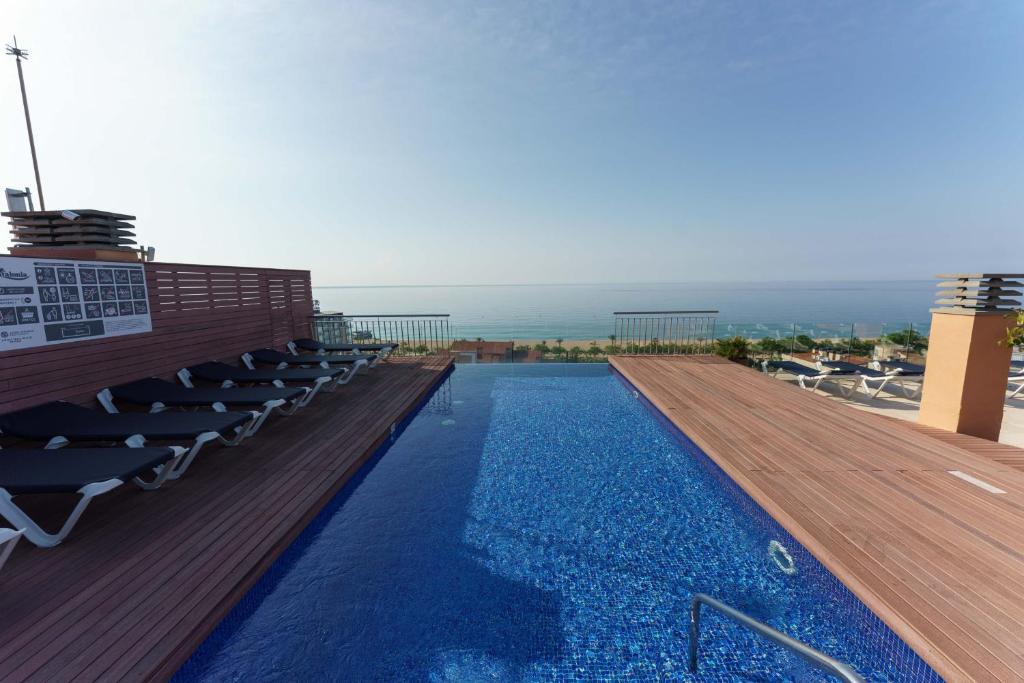 a swimming pool on the roof of a building at Checkin Catalonia in Calella