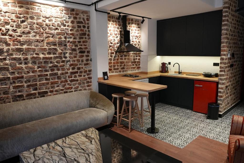 a kitchen with a bar and a brick wall at Alness Residence in Istanbul
