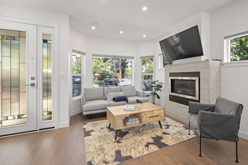 a living room with a couch and a fireplace at Oswego Paradise Retreat in Victoria