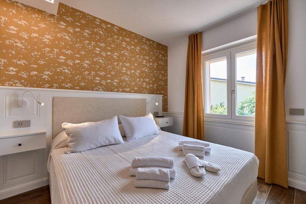 a bedroom with a bed with towels on it at Da Oscar Flowers Apartments in Barcuzzi