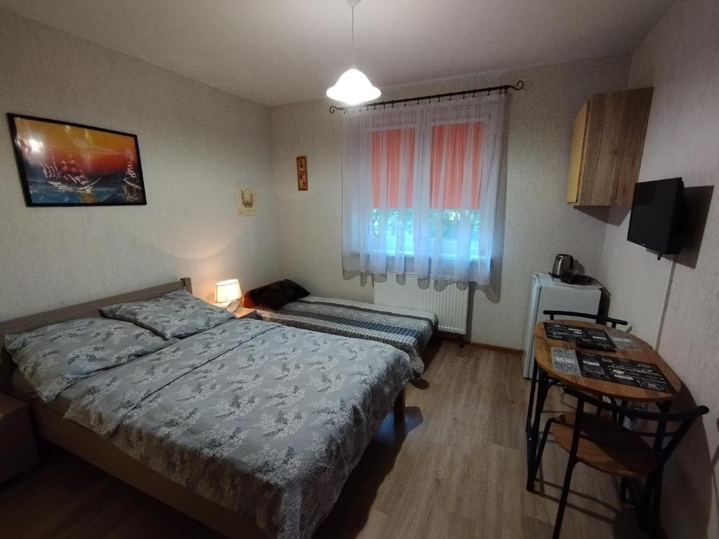 A bed or beds in a room at DOM WCZASOWY 250m OD MORZA
