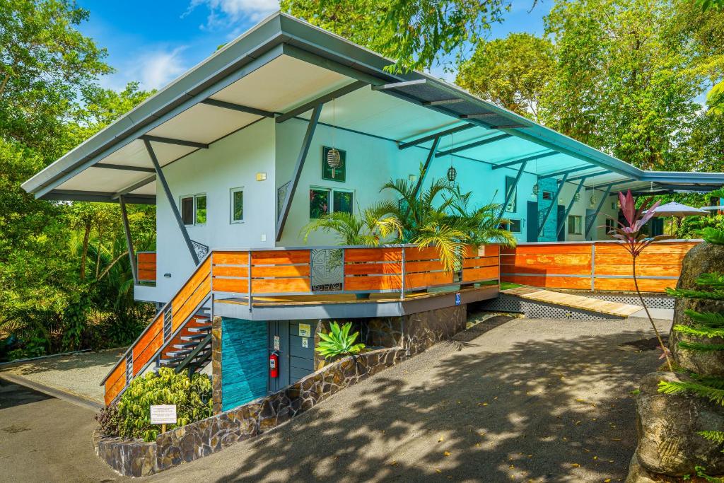a house with an orange and blue roof at Hotel FAREMITI Uvita in Uvita