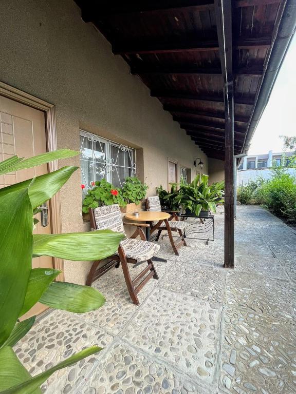 a patio with benches and tables and plants at Lotus Family Hotel - Free Parking in Sunny Beach