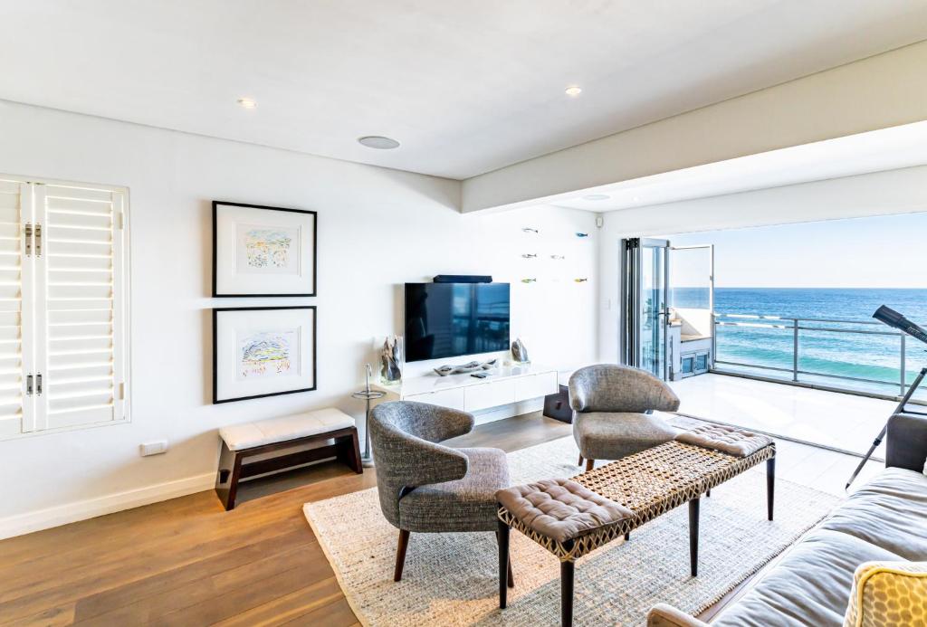 Modern Beach Front Apartment في باليتو: غرفة معيشة مطلة على المحيط