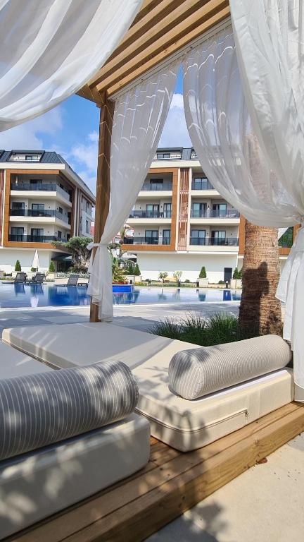 a set of inflatable mattresses under a pavilion at a resort at Family Apartment with pool Eden Valley in Alanya