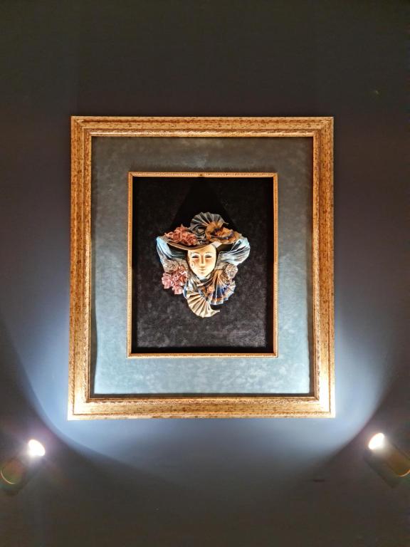 a picture of a skull in a frame on a wall at Villa Sofia in Truskavets