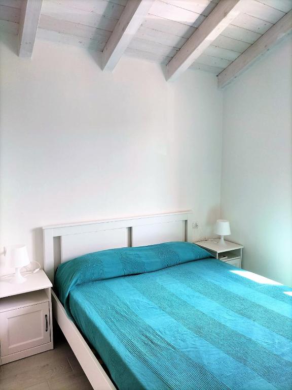 A bed or beds in a room at Affittimoderni Castelsardo La Gemma