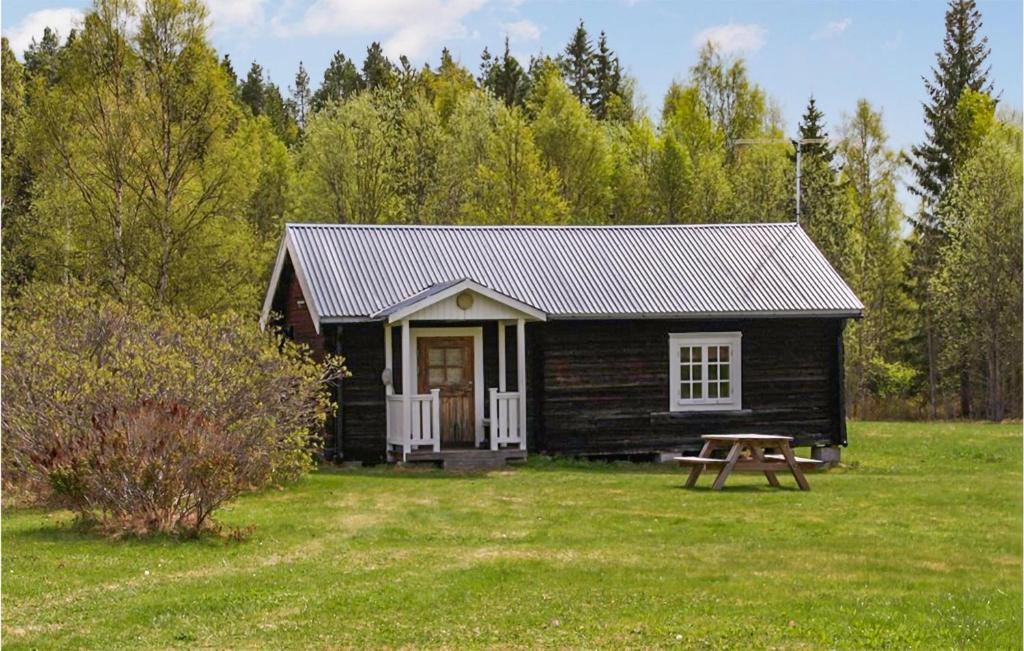 a small cabin with a picnic table in front of it at Stunning Home In Gll With 1 Bedrooms in Gällö