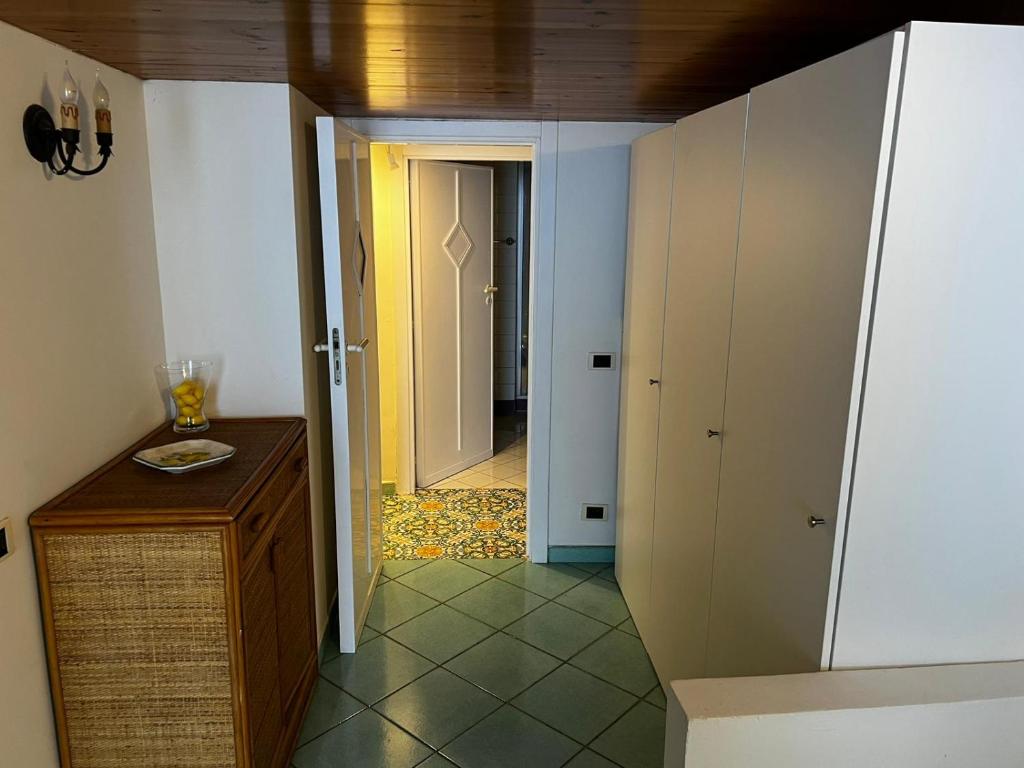 a room with a hallway with a door leading to a kitchen at Casa Vista Mare in Capri