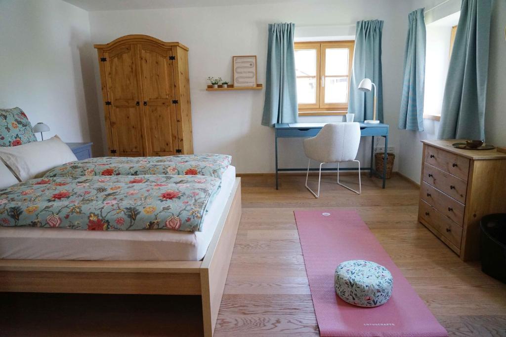 a bedroom with a bed and a desk in it at eleven Marquartstein in Marquartstein