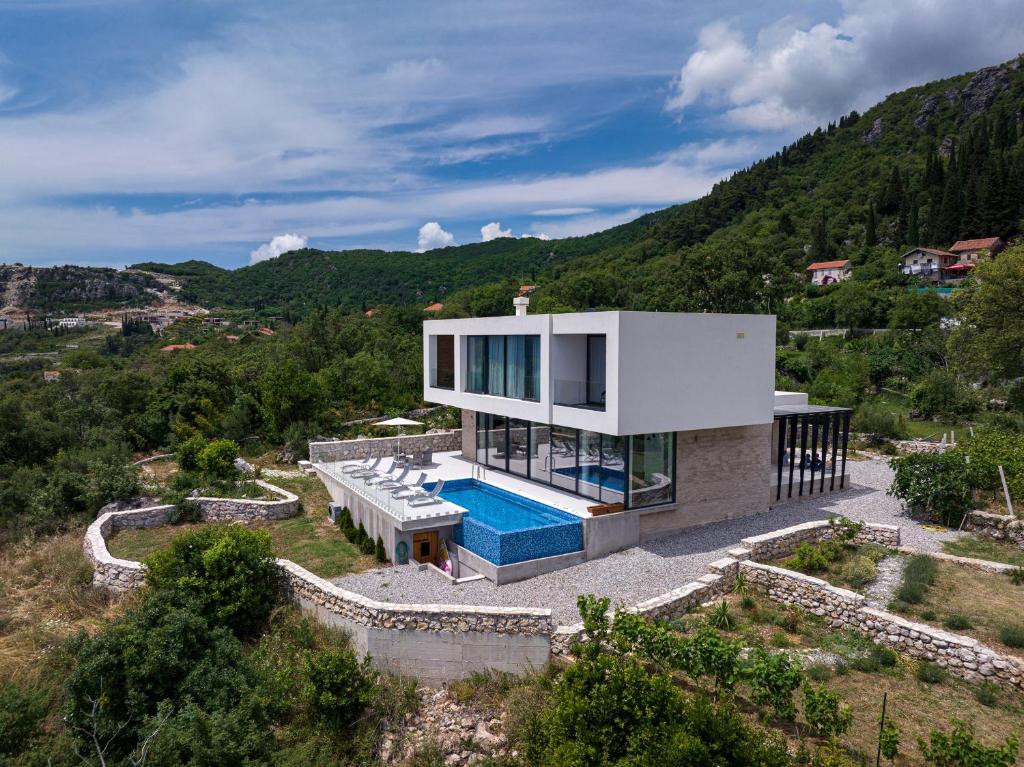 an aerial view of a house with a swimming pool at Villa Trebesin in Herceg-Novi
