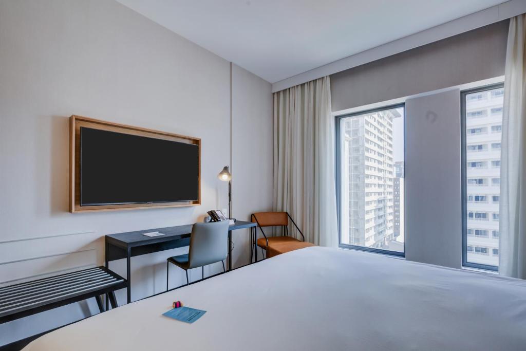Postel nebo postele na pokoji v ubytování Radisson Pinheiros