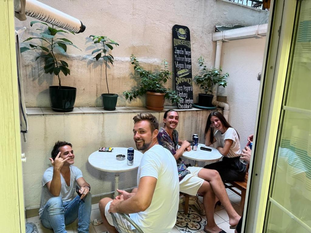 a group of people sitting at a table in a restaurant at Rodin Hostel in Istanbul