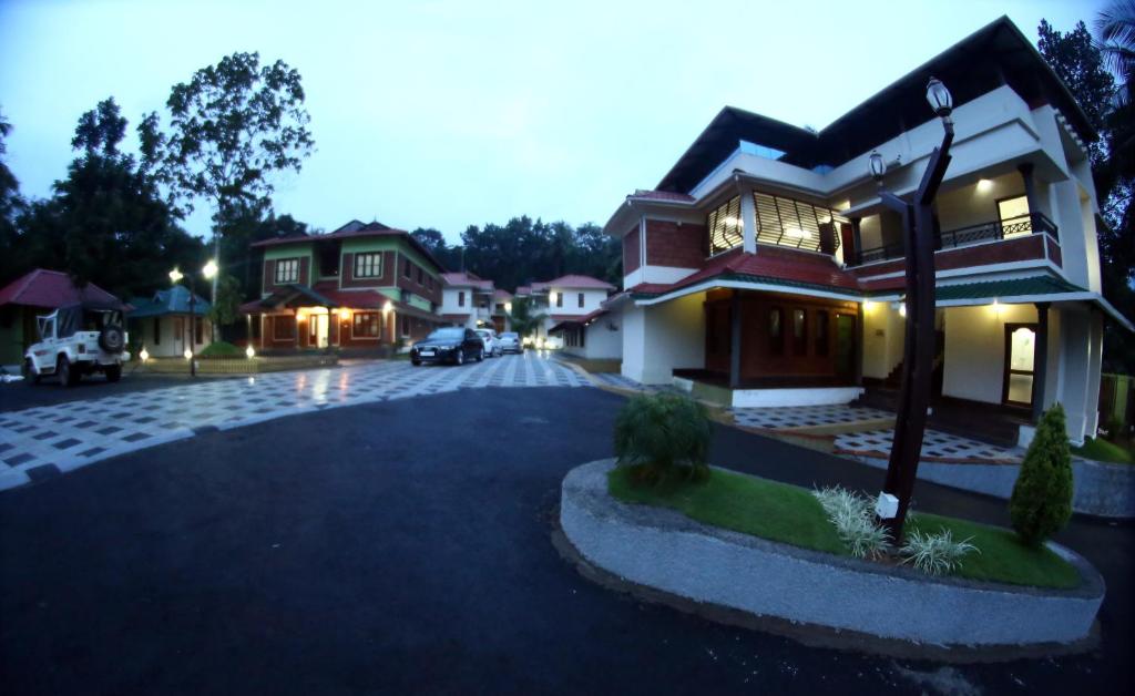a house with a car parked in a driveway at Aroma Ayur Heritage in Mattanūr