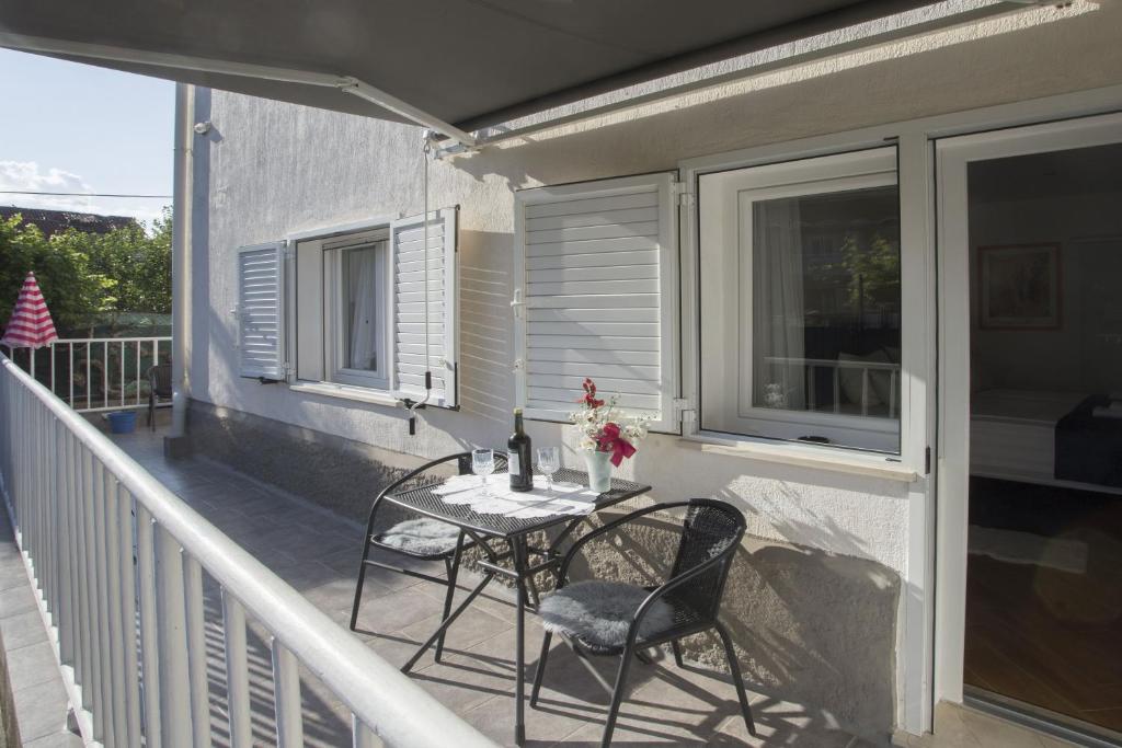 a patio with a table and chairs on a balcony at Guest House Kušeta in Split