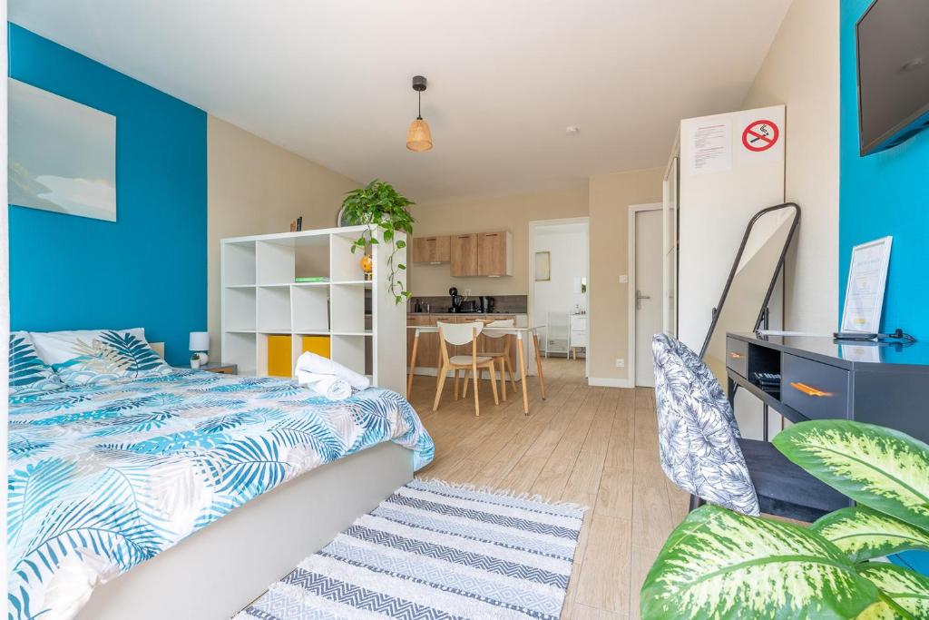 sypialnia z łóżkiem i niebieską ścianą w obiekcie Studio GDX Privilége - Bourg en Bresse - Centre ville & Gare w mieście Bourg-en-Bresse